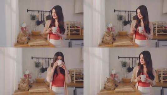 高加索年轻女子在家与家猫喝一杯咖啡。高清在线视频素材下载