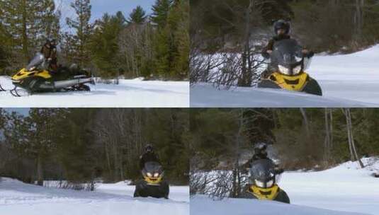 男人乘坐雪地车在森林里滑行高清在线视频素材下载
