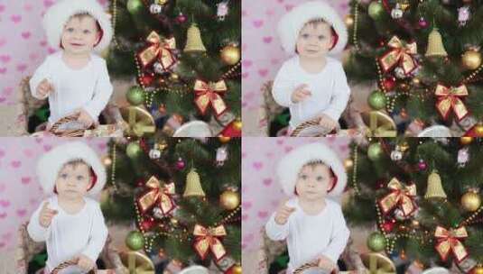 坐在圣诞树前微笑的婴儿高清在线视频素材下载