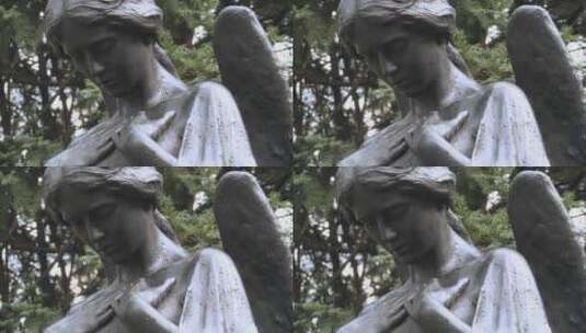 天使的雕像矗立在墓地的坟墓上高清在线视频素材下载