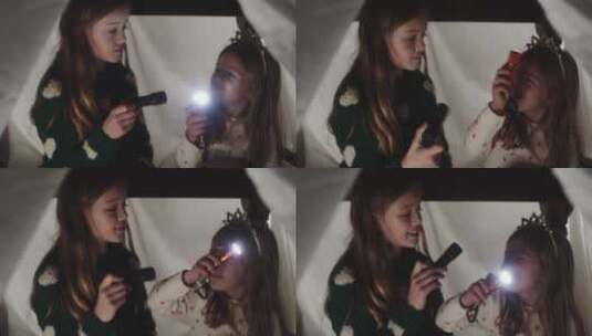 女孩在露营敞篷里玩手电筒高清在线视频素材下载