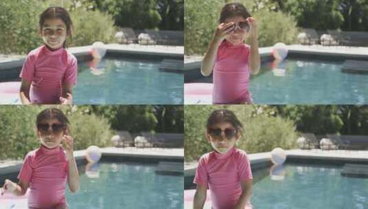 棕色头发的出生女孩穿着粉色泳衣和心形太阳高清在线视频素材下载