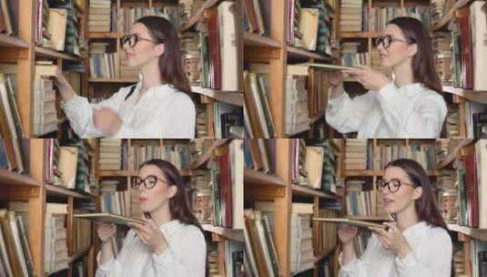 一名大学生正在图书馆的书架上寻找一本书高清在线视频素材下载