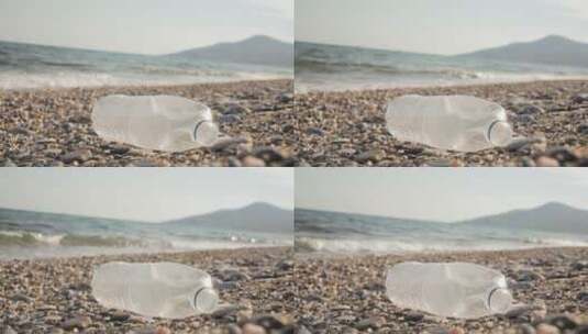 丢弃在沙滩上的废弃塑料瓶的特写高清在线视频素材下载