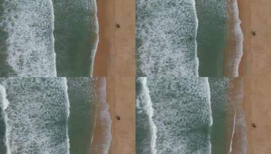 航拍下拍打沙滩的海浪高清在线视频素材下载