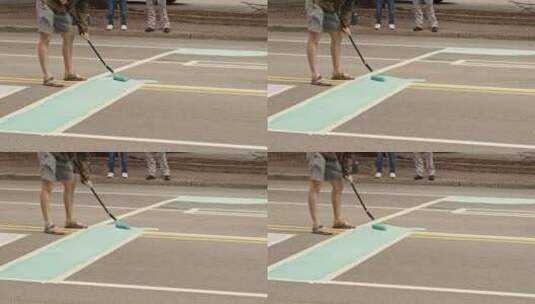 在街道上用刷子在地上画画的人高清在线视频素材下载