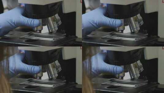 医疗技师调整显微镜高清在线视频素材下载
