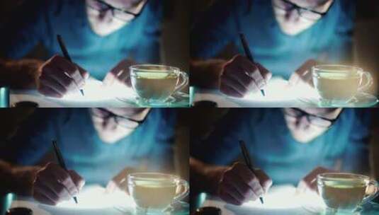 失眠男子拿着一杯茶写字高清在线视频素材下载