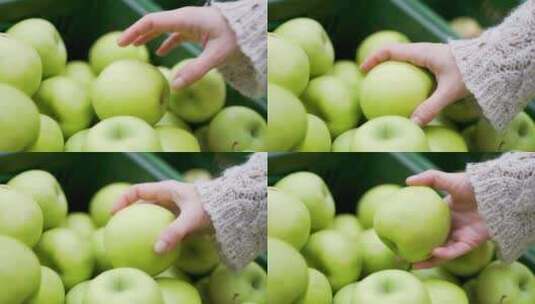 选择新鲜水果绿色苹果的手的特写高清在线视频素材下载
