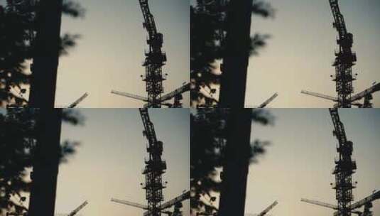 傍晚夕阳下的工地施工塔吊吊车高清在线视频素材下载