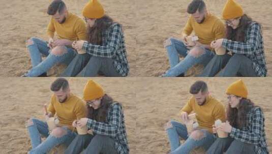 在海滩吃食物的情侣高清在线视频素材下载