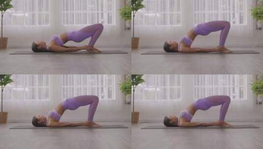 妇女在瑜伽垫上进行训练高清在线视频素材下载