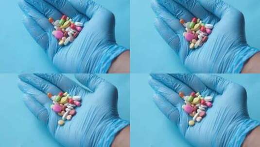 医生在蓝色手套拿着透明药丸胶囊药物高清在线视频素材下载