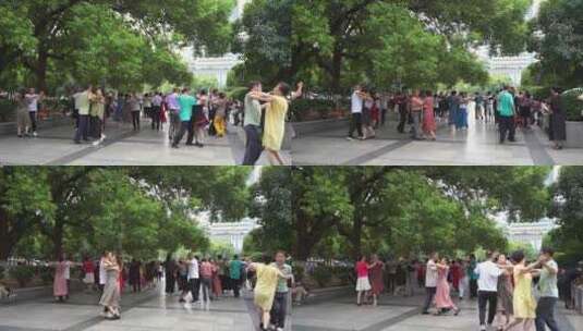 城市公园人文中老年人晨练跳广场舞休闲运动高清在线视频素材下载