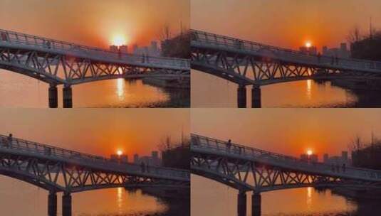 落日余晖铁架桥河流散步的人高清在线视频素材下载