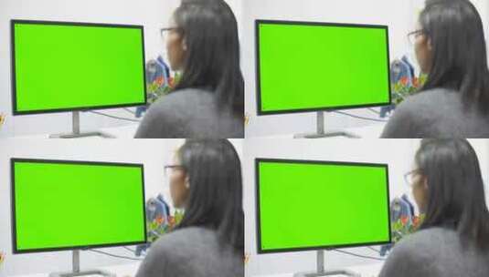 女人对着绿屏幕工作高清在线视频素材下载