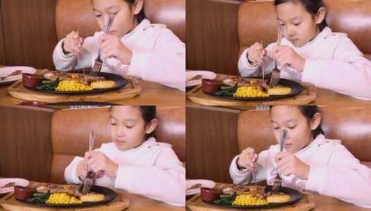 4K升格实拍堂食在西餐厅切牛排的亚洲女孩高清在线视频素材下载