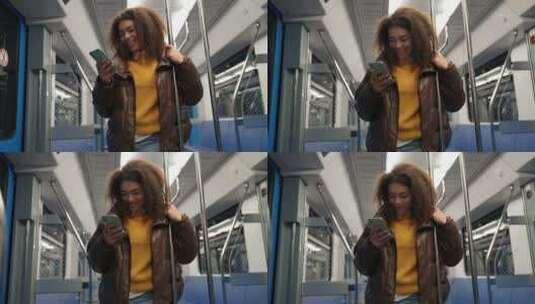 肖像开朗的非洲女性乘坐地铁并使用智能手机上网和高清在线视频素材下载