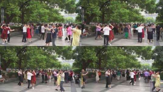 城市公园人文中老年人晨练跳广场舞休闲运动高清在线视频素材下载