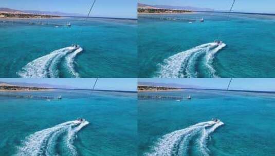 从滑翔伞运动员到红海蔚蓝水面上快艇的景色高清在线视频素材下载
