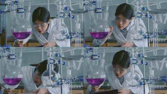 中国年轻女性在实验室观察玻璃蒸馏中的化学高清在线视频素材下载