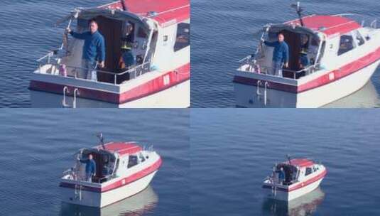 男子从船上举起一条大鳟鱼高清在线视频素材下载