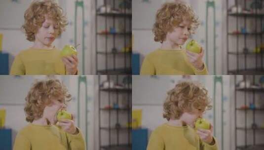 教室里吃苹果的小孩高清在线视频素材下载