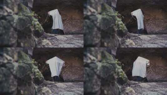 山洞里祈祷的男人高清在线视频素材下载