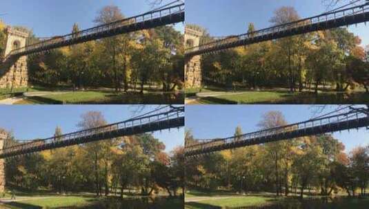 罗马尼亚克雷奥瓦——2017年10月17日，城市公园美丽湖上的吊桥高清在线视频素材下载