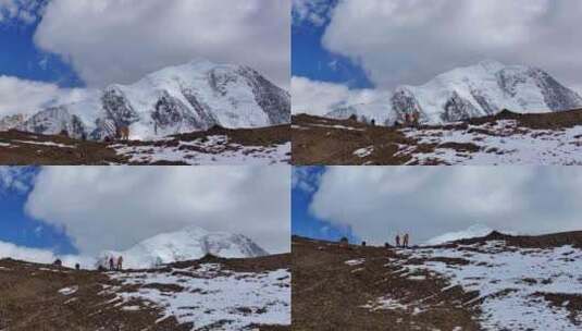 航拍垭口观看贡嘎山区雪山群峰的徒步旅行者高清在线视频素材下载