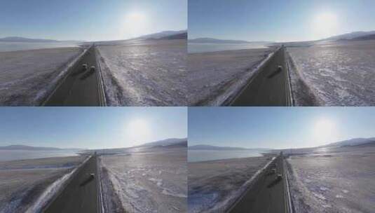 航拍冬季新疆赛里木湖环湖车辆行驶雪山公路高清在线视频素材下载