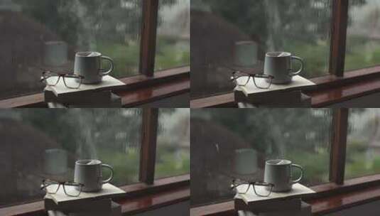 意境-下雨的窗台上放着热气腾腾的咖啡高清在线视频素材下载