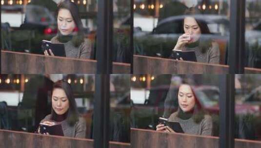 女人在城市咖啡馆喝茶，看着智能手机高清在线视频素材下载