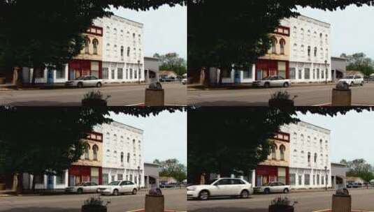汽车经过城镇的白色建筑高清在线视频素材下载