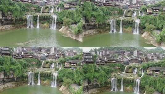航拍悬崖上的古镇瀑布流水湖南湘西芙蓉镇高清在线视频素材下载