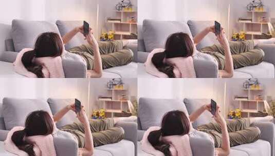 女性沙发上躺卧玩手机高清在线视频素材下载