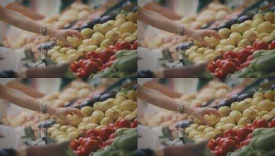 女人在水果摊前挑选柠檬高清在线视频素材下载