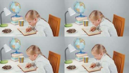 小孩边看书边吃零食高清在线视频素材下载