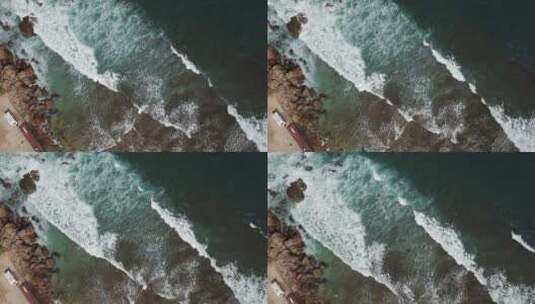 航拍海浪冲向岸边石头高清在线视频素材下载