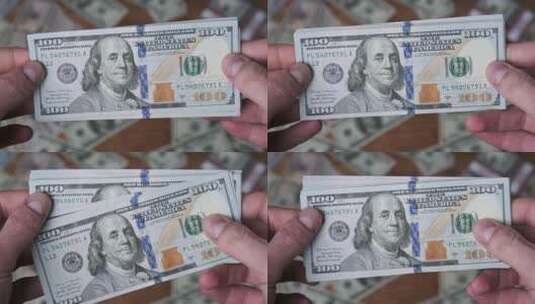 商务人士拿着一张张面值100美元的纸质货币高清在线视频素材下载