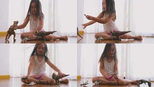 小女孩坐在地板上玩恐龙玩具高清在线视频素材下载