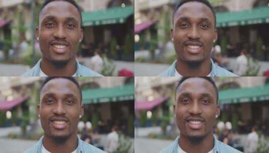 非洲裔美国人白天在舒适的街头咖啡馆附近用幸运的脸看着相机高清在线视频素材下载