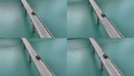 航拍湖泊桥上黑色汽车行驶高清在线视频素材下载