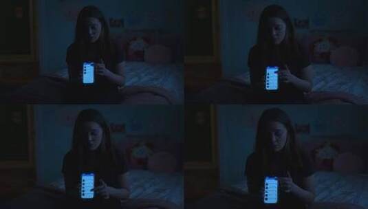 女孩夜晚在床上使用智能手机高清在线视频素材下载