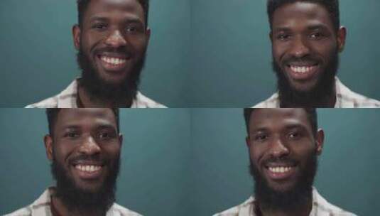 一个有吸引力的黑人对着镜头微笑，朝不同的方向摇摆高清在线视频素材下载