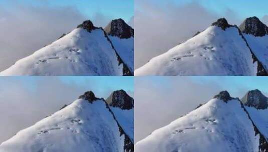 航拍攀登横断山脉乌库楚雪山山脊上的登山者高清在线视频素材下载