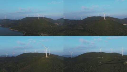 航拍崇山峻岭间山顶的水库与风力发电场风机高清在线视频素材下载