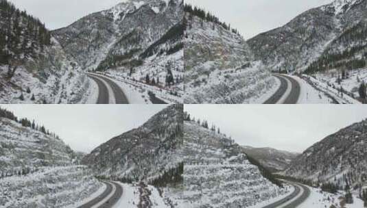 航拍山谷里被大雪掩盖的道路高清在线视频素材下载