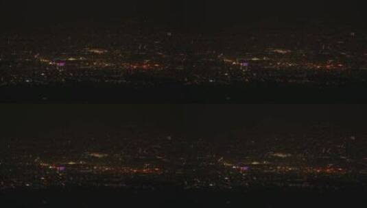 从远处看黑夜中的城市灯光高清在线视频素材下载