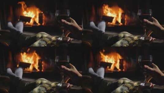 拿着红酒坐在壁炉前高清在线视频素材下载